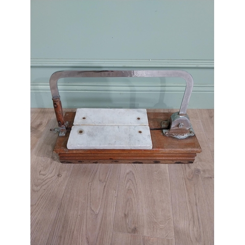 13 - Chrome and marble cheese cutter mounted on mahogany base {77 cm H x 60 cm W x 22 cm D}.