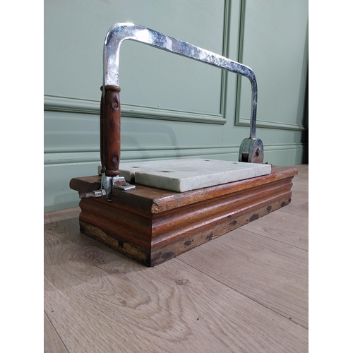 13 - Chrome and marble cheese cutter mounted on mahogany base {77 cm H x 60 cm W x 22 cm D}.