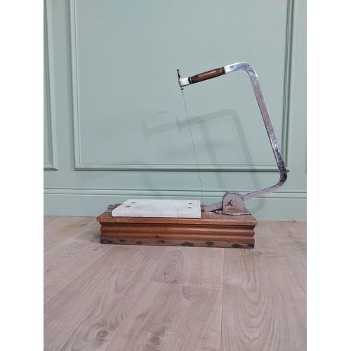 13 - Chrome and marble cheese cutter mounted on mahogany base {77 cm H x 60 cm W x 22 cm D}.