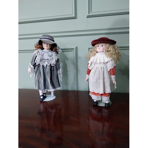 1301 - Two vintage porcelain children's dolls in the early 20th C. clothing {Approx. 45 cm H x 23 cm Dia.}.