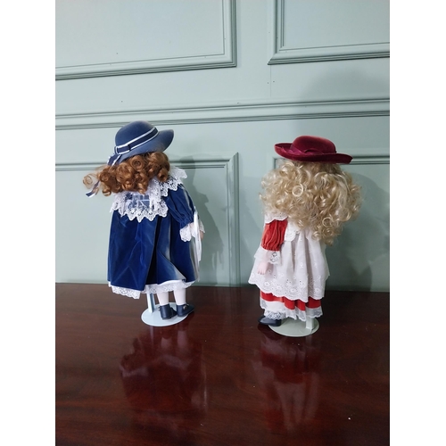 1301 - Two vintage porcelain children's dolls in the early 20th C. clothing {Approx. 45 cm H x 23 cm Dia.}.