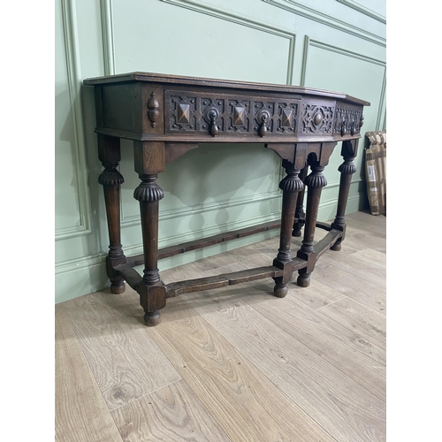 1314 - Carved oak side table with two drawers in the frieze raised on turned legs{77 cm H x 122 cm W x 52 c... 