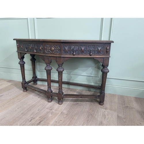 1314 - Carved oak side table with two drawers in the frieze raised on turned legs{77 cm H x 122 cm W x 52 c... 