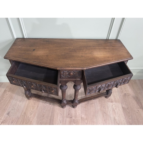 1314 - Carved oak side table with two drawers in the frieze raised on turned legs{77 cm H x 122 cm W x 52 c... 