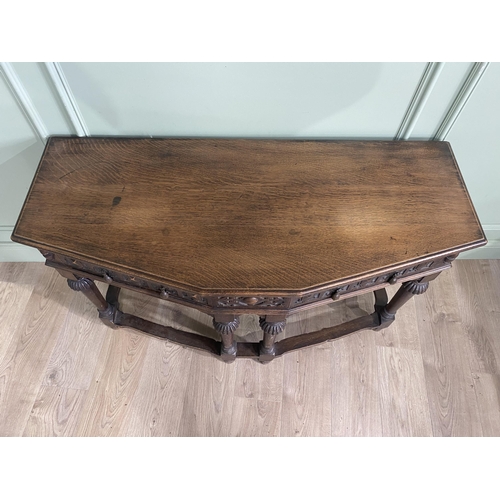 1314 - Carved oak side table with two drawers in the frieze raised on turned legs{77 cm H x 122 cm W x 52 c... 