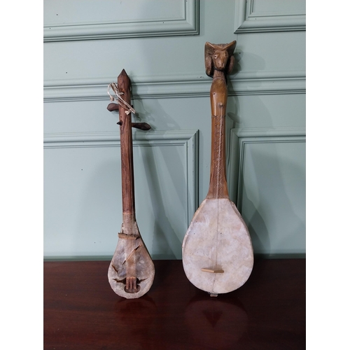 1321 - Two Primitive Middle Eastern musical instruments {59 cm H AND 55 cm H}.