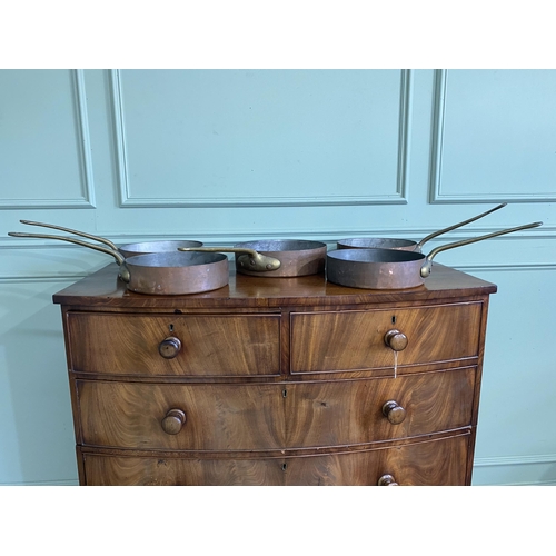 1331 - Collection of five copper saucepans with brass handles {Approx. 11 cm H x 58 cm W x 28 cm D}.