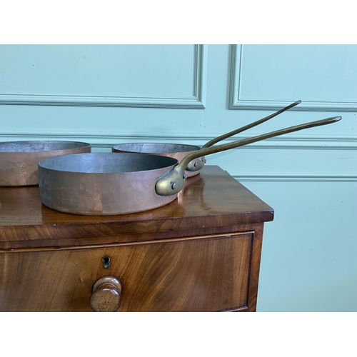 1331 - Collection of five copper saucepans with brass handles {Approx. 11 cm H x 58 cm W x 28 cm D}.