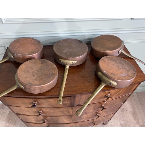 1331 - Collection of five copper saucepans with brass handles {Approx. 11 cm H x 58 cm W x 28 cm D}.