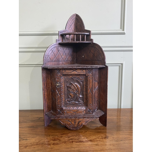 1332 - Edwardian carved oak wall hanging corner cupboard {73 cm H x 40 cm W x 30 cm D}.