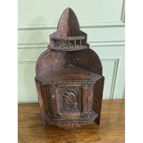 1332 - Edwardian carved oak wall hanging corner cupboard {73 cm H x 40 cm W x 30 cm D}.