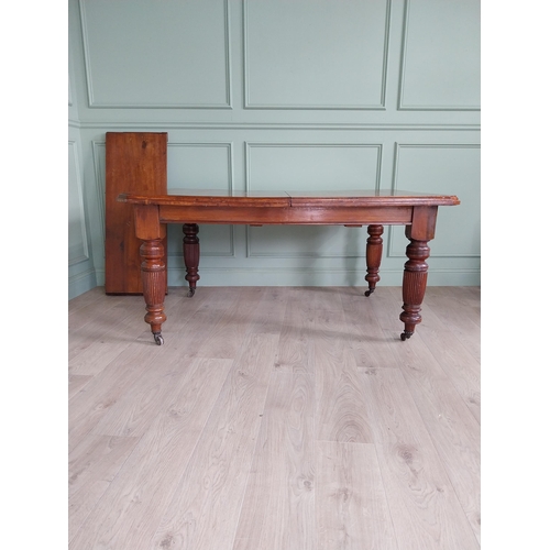 1340 - Edwardian mahogany cut corner dining table raised on reeded legs with one extra leaf {76 cm H x 155 ... 