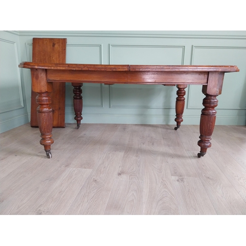 1340 - Edwardian mahogany cut corner dining table raised on reeded legs with one extra leaf {76 cm H x 155 ... 