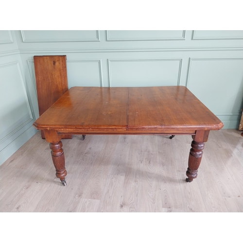 1340 - Edwardian mahogany cut corner dining table raised on reeded legs with one extra leaf {76 cm H x 155 ... 