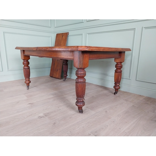 1340 - Edwardian mahogany cut corner dining table raised on reeded legs with one extra leaf {76 cm H x 155 ... 