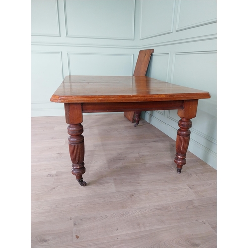 1340 - Edwardian mahogany cut corner dining table raised on reeded legs with one extra leaf {76 cm H x 155 ... 