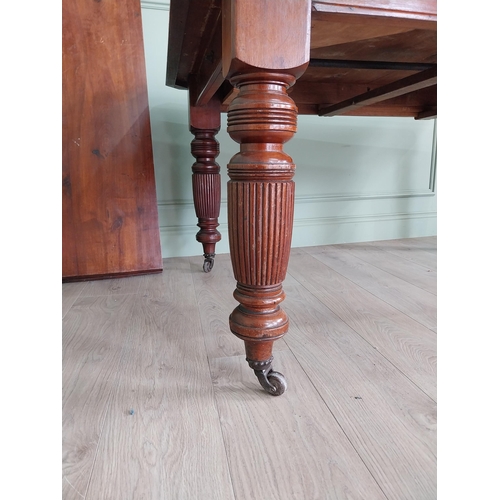 1340 - Edwardian mahogany cut corner dining table raised on reeded legs with one extra leaf {76 cm H x 155 ... 