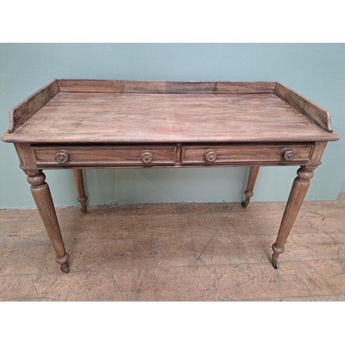 1347 - Pine side table with two drawers in the frieze raised on turned legs and castors  {H 80cm x W 115cm ... 