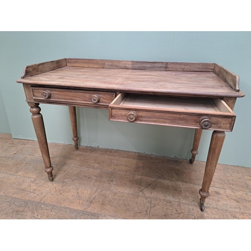 1347 - Pine side table with two drawers in the frieze raised on turned legs and castors  {H 80cm x W 115cm ... 