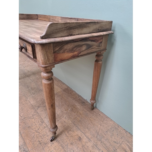 1347 - Pine side table with two drawers in the frieze raised on turned legs and castors  {H 80cm x W 115cm ... 