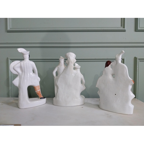 135 - Three Staffordshire ceramic figures {40 cm H, 37 cm H and 36 cm H}.