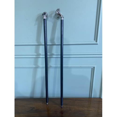 1389 - Two ebony walking sticks with chrome tops {96 cm H and 93 cm H}.