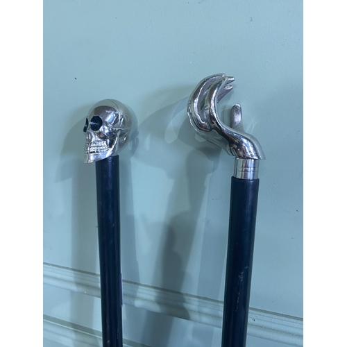 1389 - Two ebony walking sticks with chrome tops {96 cm H and 93 cm H}.