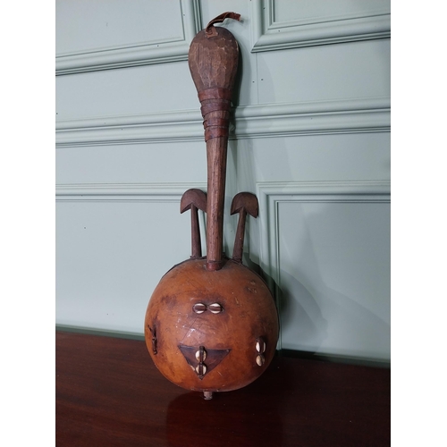 1393 - Primitive African musical instrument decorated with sea shells {64 cm H x 26 cm W x 16 cm D}.