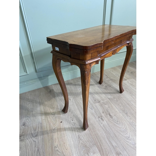 1396 - French walnut and satinwood inlaid turn over leaf card table raised on cabriole legs in the Victoria... 