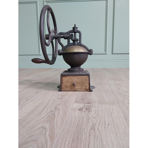 148 - Early 20th C. cast iron and brass wheel coffee grinder {50 cm H x 40 cm W x 34 cm D}.