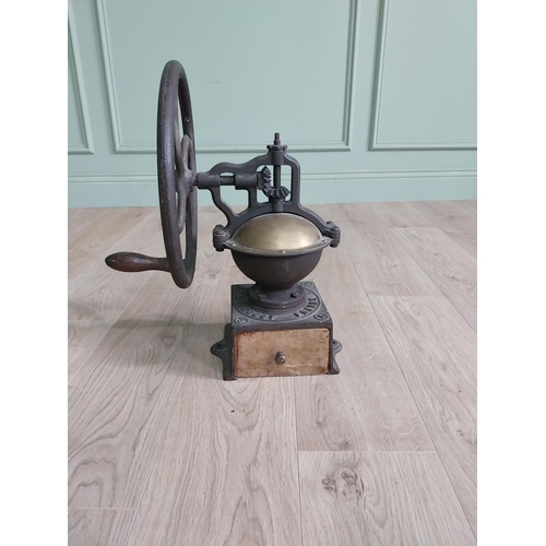 148 - Early 20th C. cast iron and brass wheel coffee grinder {50 cm H x 40 cm W x 34 cm D}.