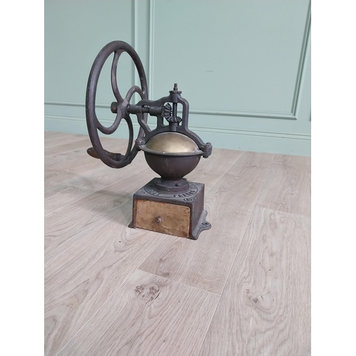 148 - Early 20th C. cast iron and brass wheel coffee grinder {50 cm H x 40 cm W x 34 cm D}.