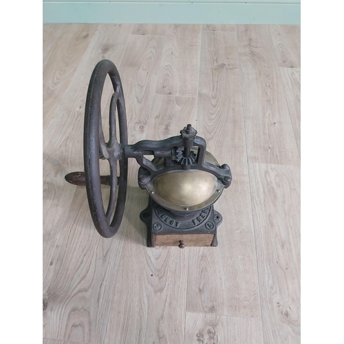 148 - Early 20th C. cast iron and brass wheel coffee grinder {50 cm H x 40 cm W x 34 cm D}.