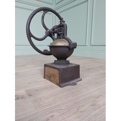 148 - Early 20th C. cast iron and brass wheel coffee grinder {50 cm H x 40 cm W x 34 cm D}.