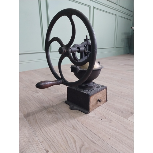 148 - Early 20th C. cast iron and brass wheel coffee grinder {50 cm H x 40 cm W x 34 cm D}.