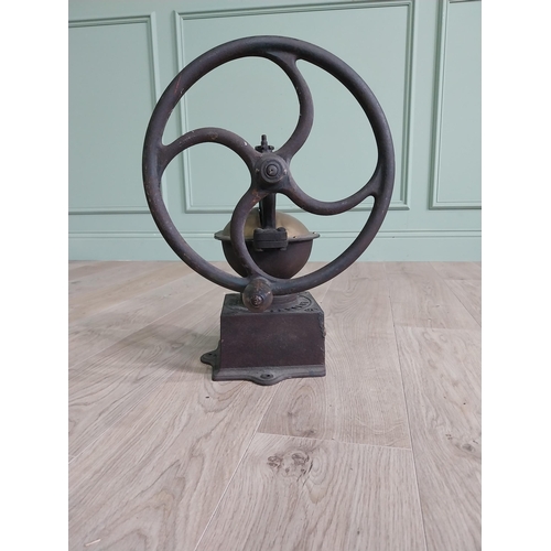 148 - Early 20th C. cast iron and brass wheel coffee grinder {50 cm H x 40 cm W x 34 cm D}.