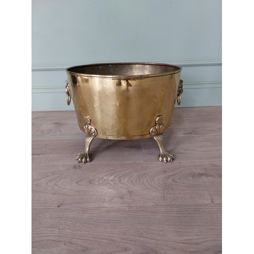 156 - Edwardian brass log bucket with lions mask handles raised on lion paw feet {30 cm H x 48 cm W x 30 c... 