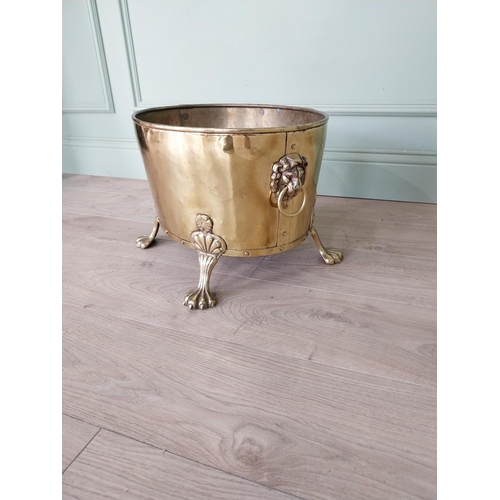 156 - Edwardian brass log bucket with lions mask handles raised on lion paw feet {30 cm H x 48 cm W x 30 c... 