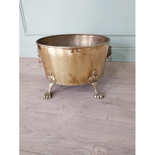 156 - Edwardian brass log bucket with lions mask handles raised on lion paw feet {30 cm H x 48 cm W x 30 c... 