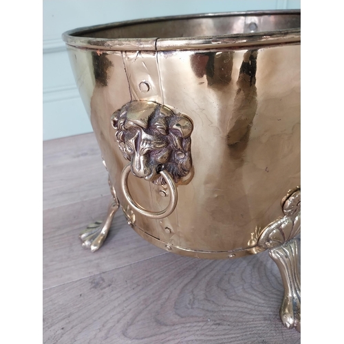 156 - Edwardian brass log bucket with lions mask handles raised on lion paw feet {30 cm H x 48 cm W x 30 c... 