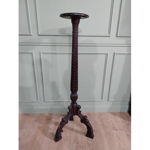 157 - 19th C. carved mahogany torchiere raised on three out swept feet {153 cm H x 50 cm Dia.}.