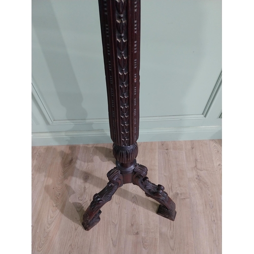 157 - 19th C. carved mahogany torchiere raised on three out swept feet {153 cm H x 50 cm Dia.}.