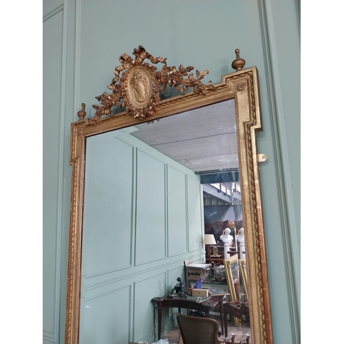 163 - 19th C. French gilt mirror with floral decoration surmounted with female mask and bows. {168 cm H x ... 