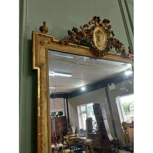 163 - 19th C. French gilt mirror with floral decoration surmounted with female mask and bows. {168 cm H x ... 