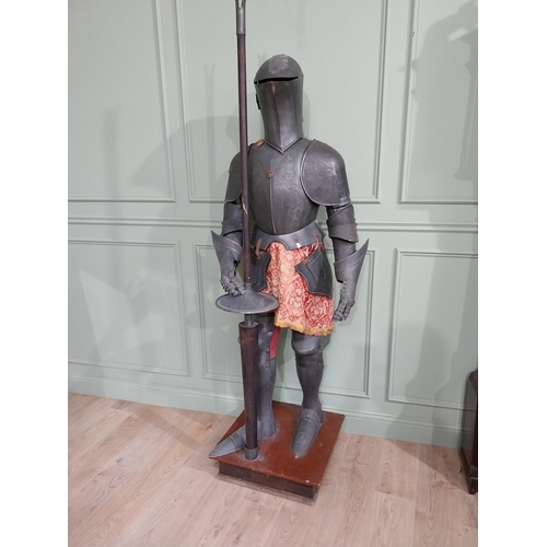 183 - Decorative engraved metal Suit of Amour raised on platform base {214 cm H x 72 cm W x 60 cm D}.