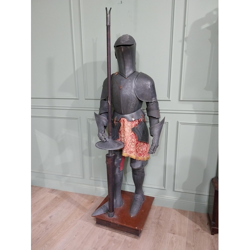 183 - Decorative engraved metal Suit of Amour raised on platform base {214 cm H x 72 cm W x 60 cm D}.