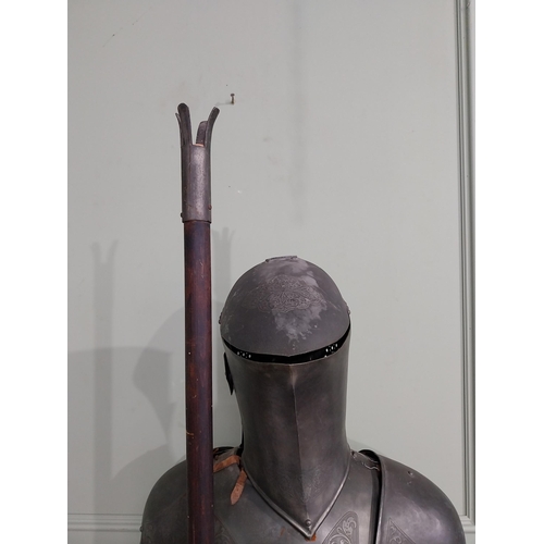 183 - Decorative engraved metal Suit of Amour raised on platform base {214 cm H x 72 cm W x 60 cm D}.