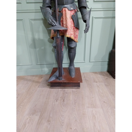 183 - Decorative engraved metal Suit of Amour raised on platform base {214 cm H x 72 cm W x 60 cm D}.