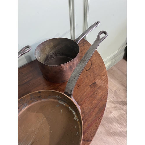 195 - Three early 20th C. heavy copper saucepans with wrought iron handles {18 cm H x 47 cm W x 22 cm D an... 