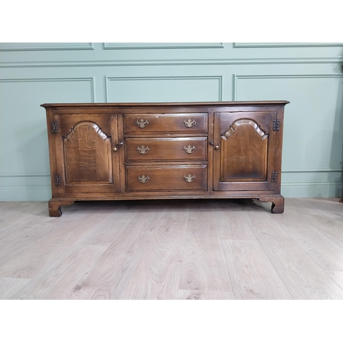 197 - Good quality oak side cabinet with three drawers flanked by two blind doors raised on bracket feet i... 